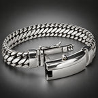 A silver-toned metal chain bracelet with a polished rectangular clasp, shown on a light gray background.