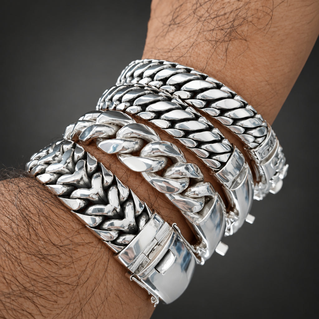 Close-up of a wrist wearing multiple silver bracelets with a blurred background