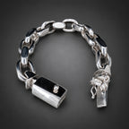 Silver chain bracelet with lock charm on a dark background