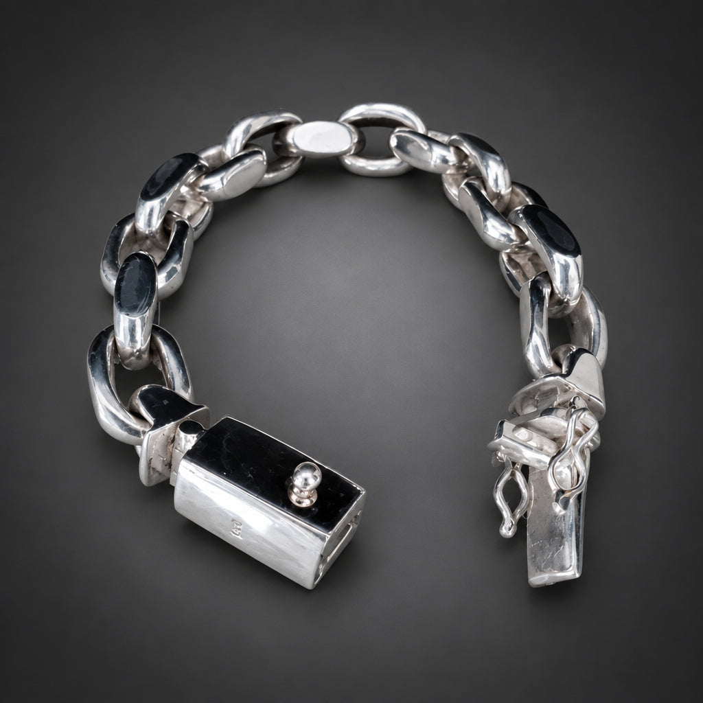 Silver chain bracelet with lock charm on a dark background