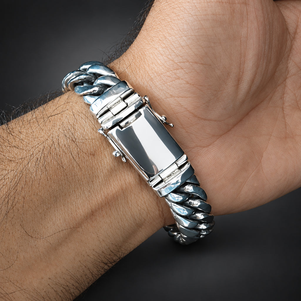Silver bracelet on a wrist with a dark background
