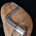 Silver bracelet on a wooden block with a dark background