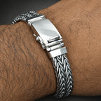Silver bracelet with a clasp on a wrist with visible skin texture
