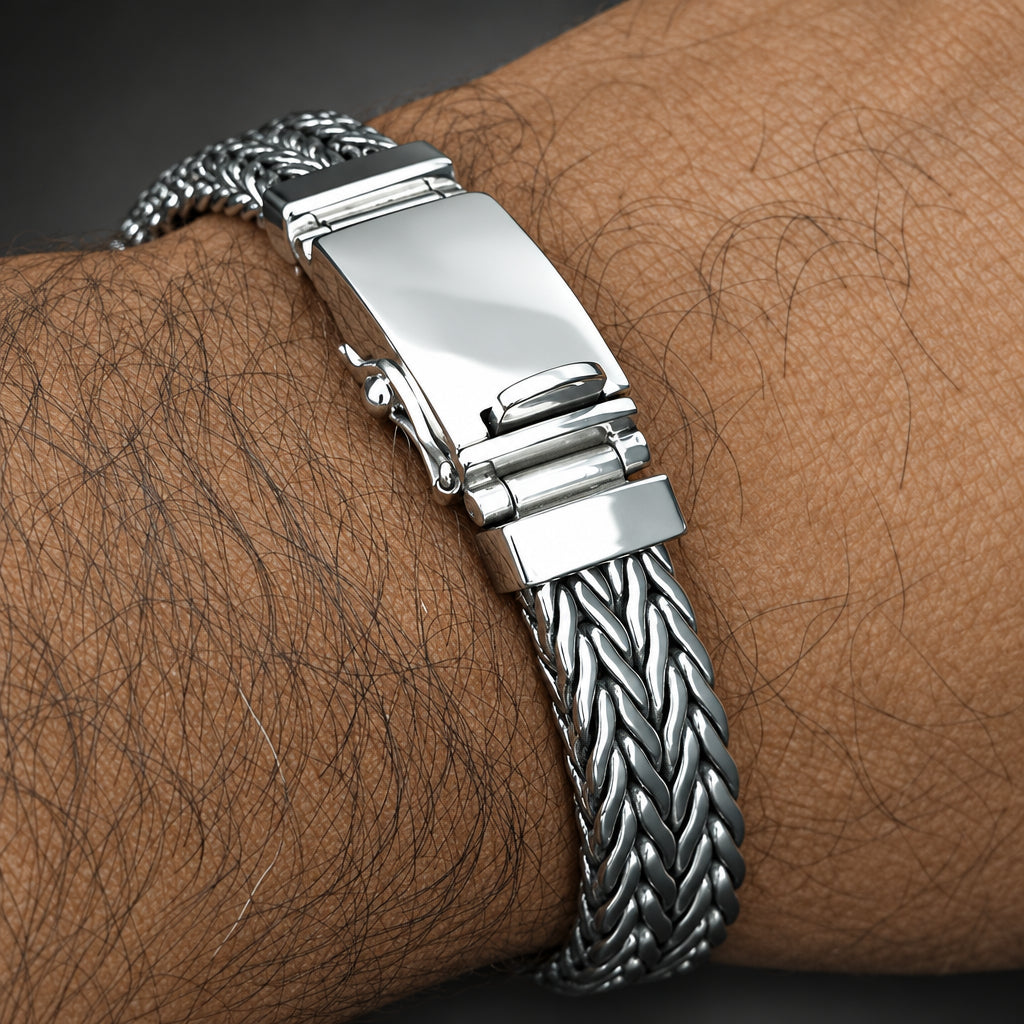 Silver bracelet with a clasp on a wrist with visible skin texture