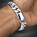 Silver bracelet on a wrist with a dark grey background
