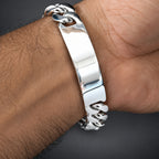 Silver bracelet on a wrist with a dark background