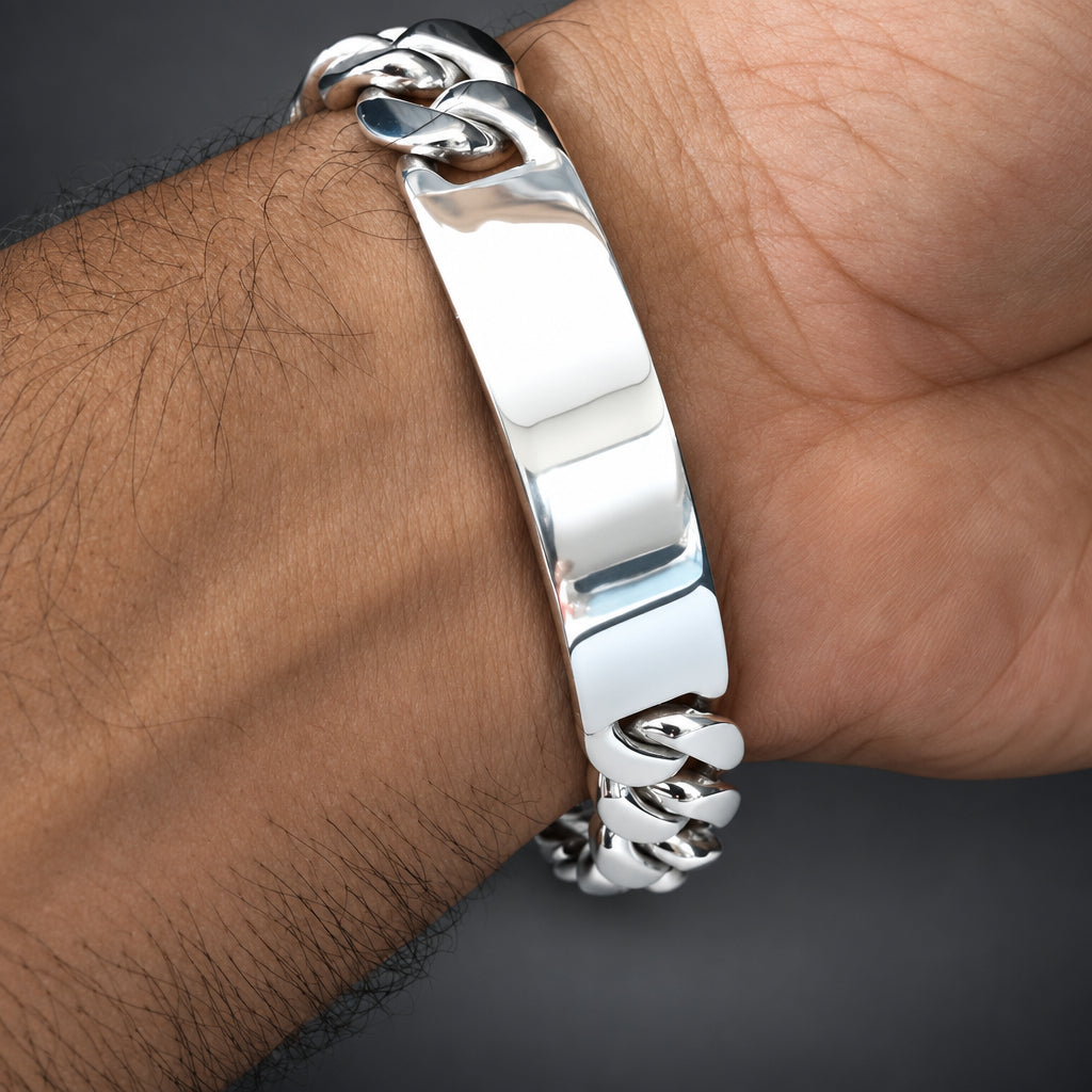 Silver bracelet on a wrist with a dark background