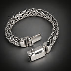 Silver braided bracelet on a dark gray background