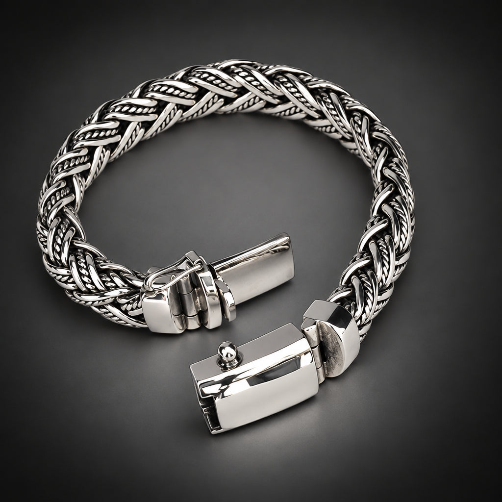 Silver braided bracelet on a dark gray background