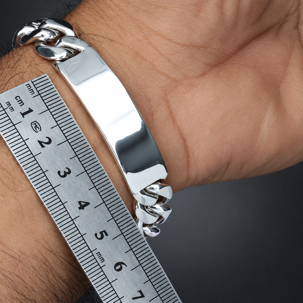 Silver bracelet on a wrist with a ruler for size reference