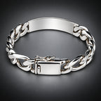 A polished silver-tone metal chain bracelet with a rectangular ID plate and a secure clasp, shown on a neutral gray background.