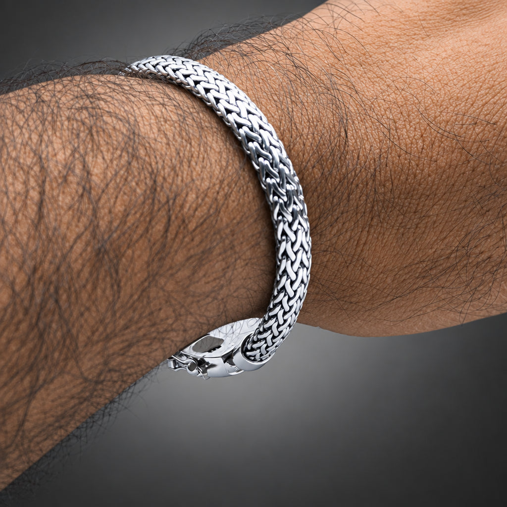 Silver bracelet on a wrist with a light background