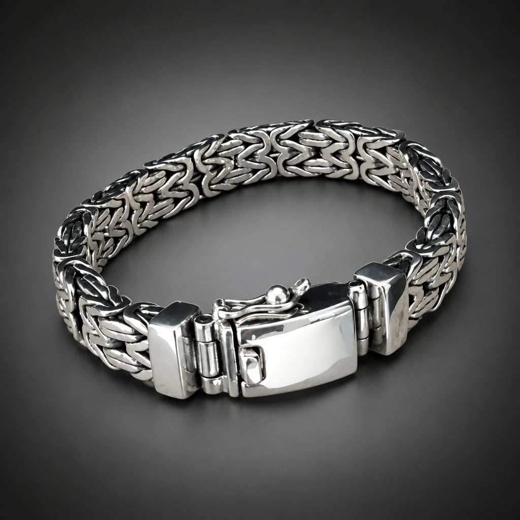 Silver bracelet with a textured band on a wooden surface