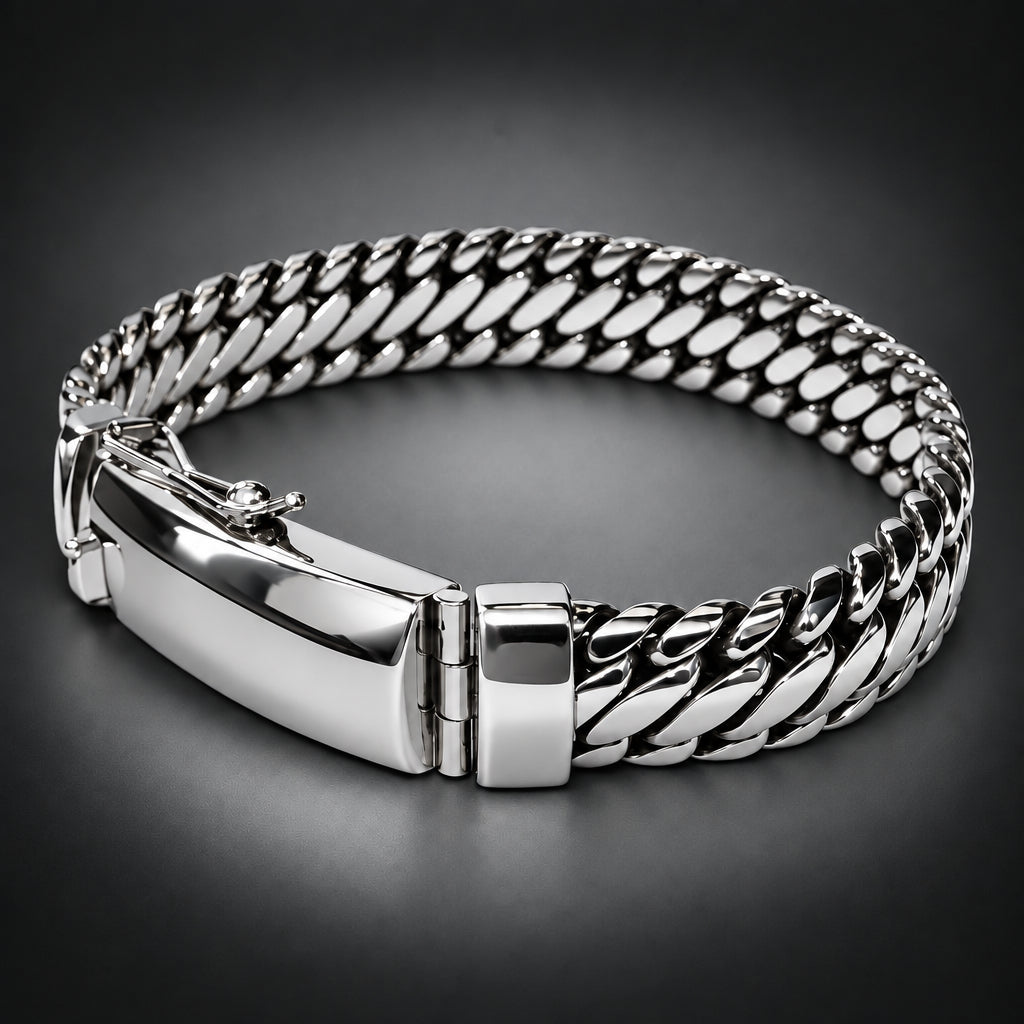 A silver-toned metal bracelet with a curb-style chain link design and a polished clasp, photographed on a plain dark background.