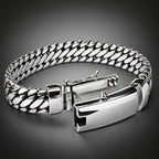 Silver chain bracelet on a light gray background