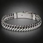 Silver chain bracelet on a gray background