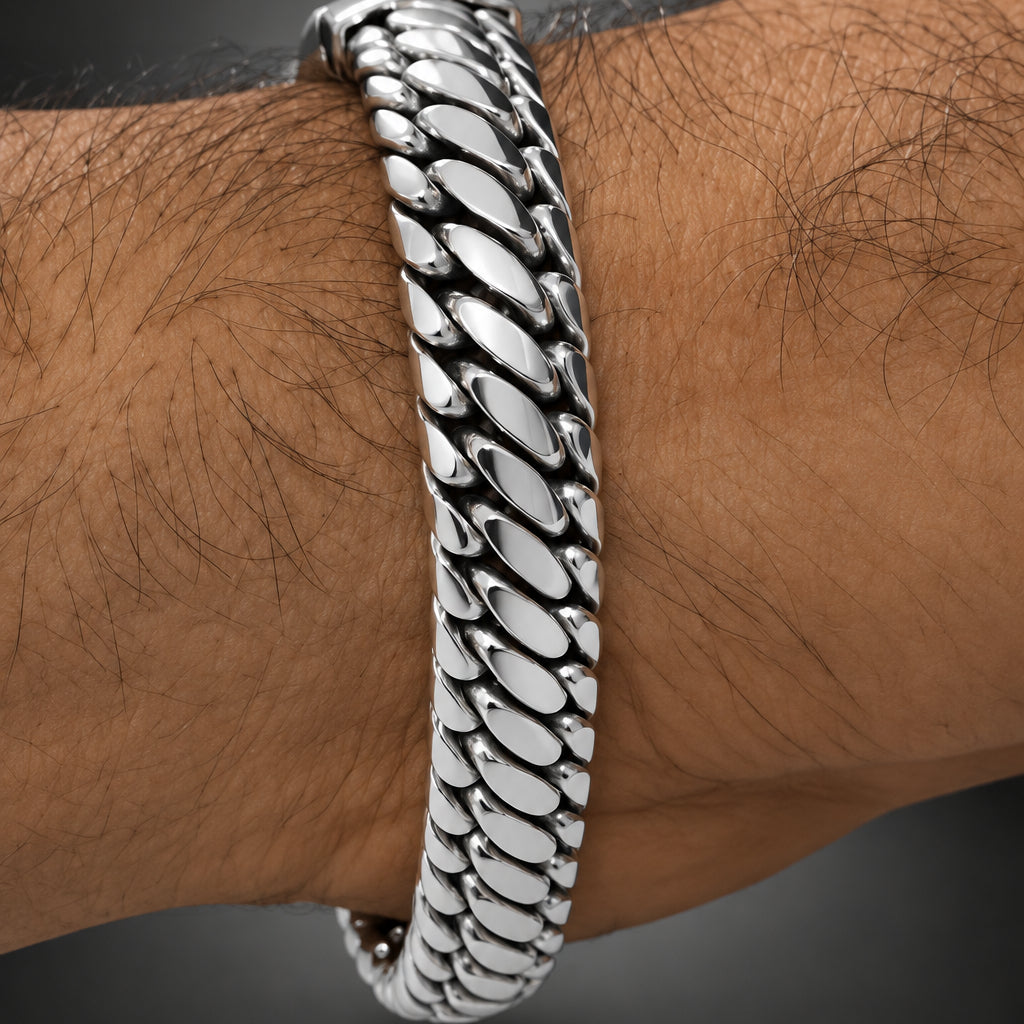 Silver chain bracelet on a wrist with a blurred background