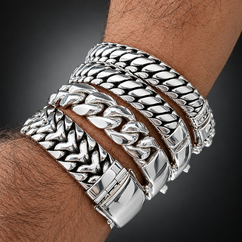 Close-up of a wrist wearing multiple silver bracelets with a blurred background