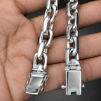 Silver chain with padlock ends held between fingers
