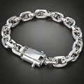 A silver-toned chunky chain link bracelet with a rectangular clasp, displayed on a dark gray gradient background.