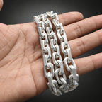 Silver chain bracelet on a person's wrist with a blurred background
