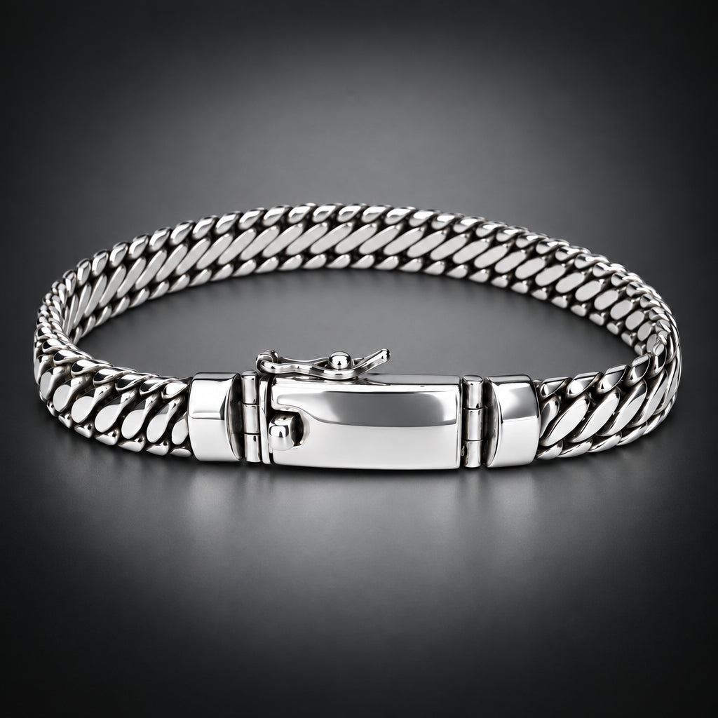 A silver-toned braided chain bracelet with a polished clasp, displayed on a neutral light gray background.