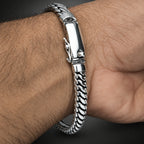 Silver bracelet with textured design on a wrist