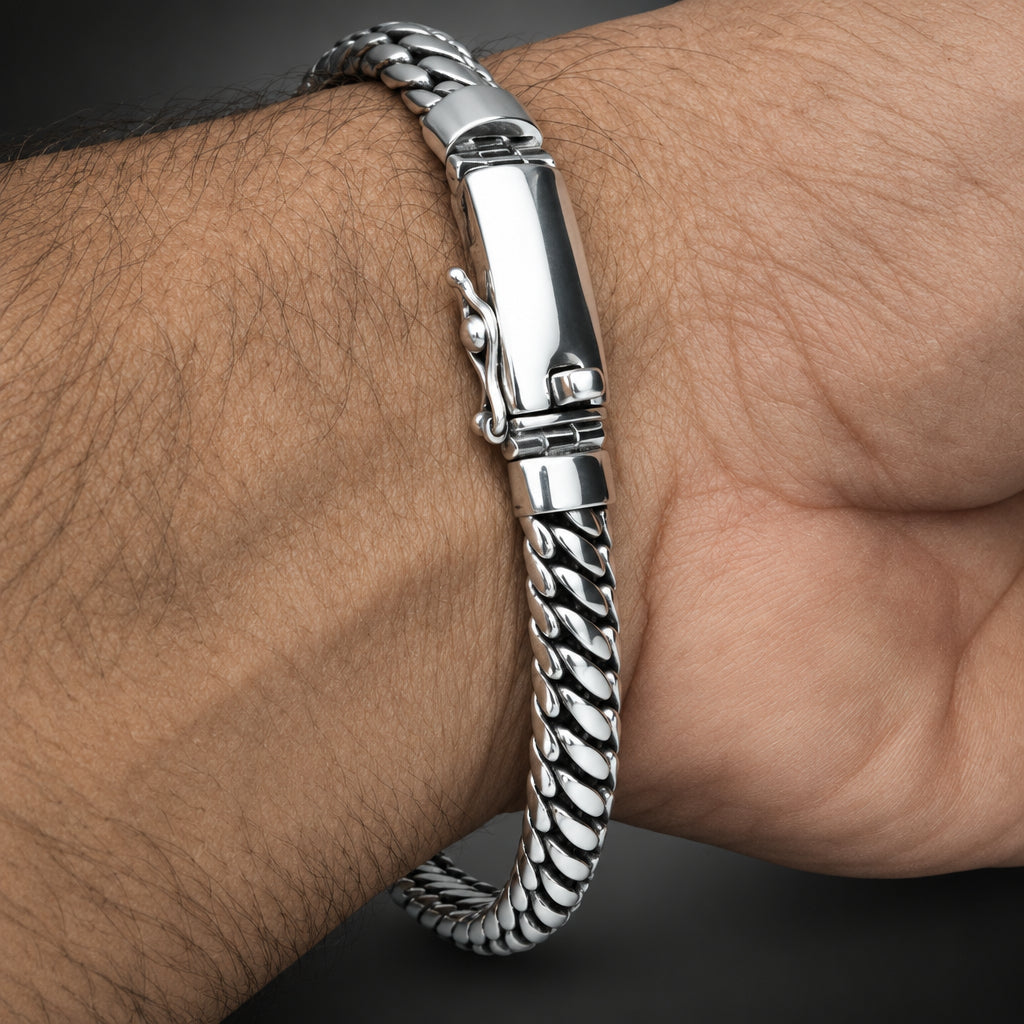Silver bracelet with textured design on a wrist