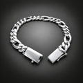 A silver-toned Cuban link chain bracelet with a polished rectangular clasp, displayed open on a dark gray gradient background.
