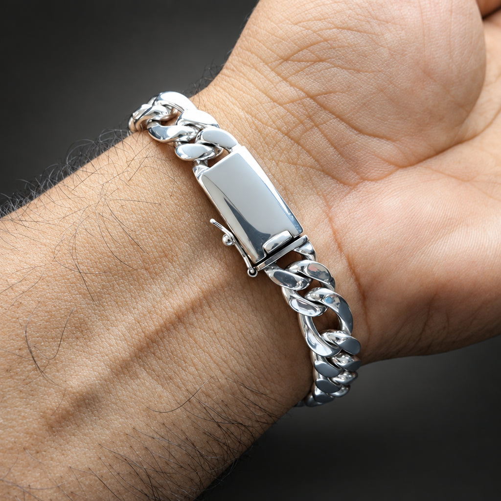 Silver chain bracelet on a wrist with a dark background