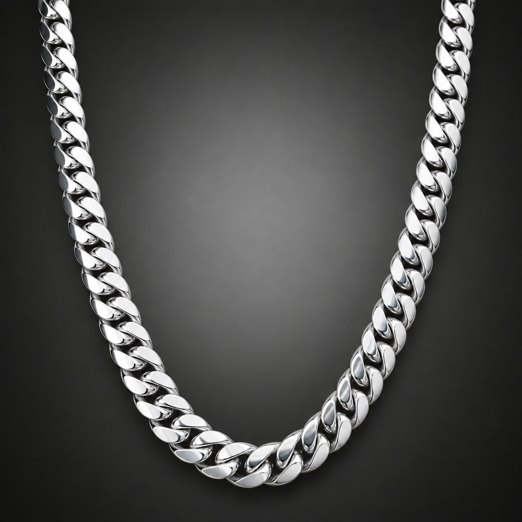 A polished silver-tone Cuban link chain necklace draped in a U-shape over a light brown wooden surface.