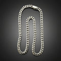 A silver-toned Cuban link chain necklace with a lobster clasp, displayed on a dark black background.