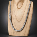 Silver chain necklace on a wooden surface
