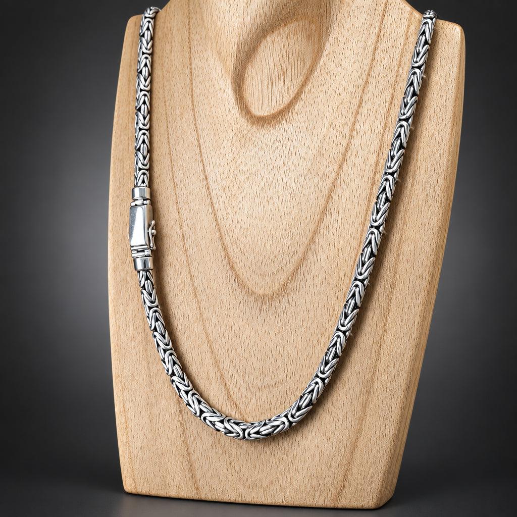 Silver chain necklace on a wooden surface