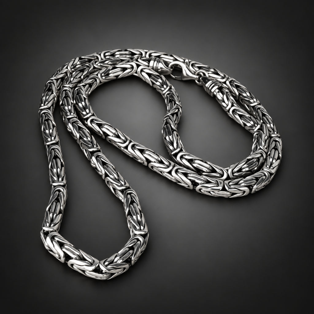 Silver braided necklace on a dark background