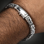 Silver bracelet on a wrist with a textured design