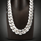 Silver chain necklace on a dark wooden block