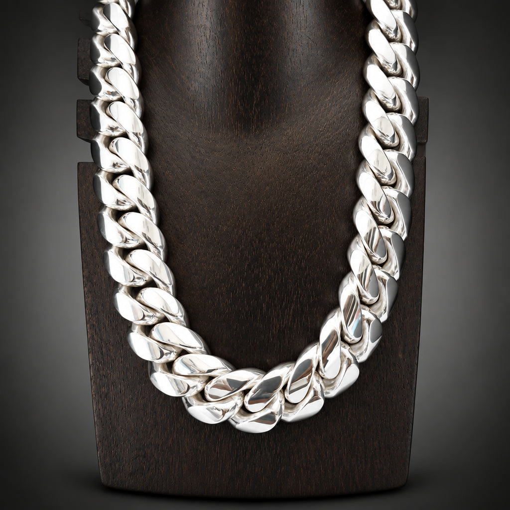 Silver chain necklace on a dark wooden block