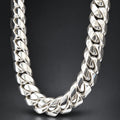 Silver chain necklace on a dark textured background