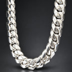Silver chain necklace on a dark textured background