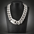 Silver chain necklace on a black stand