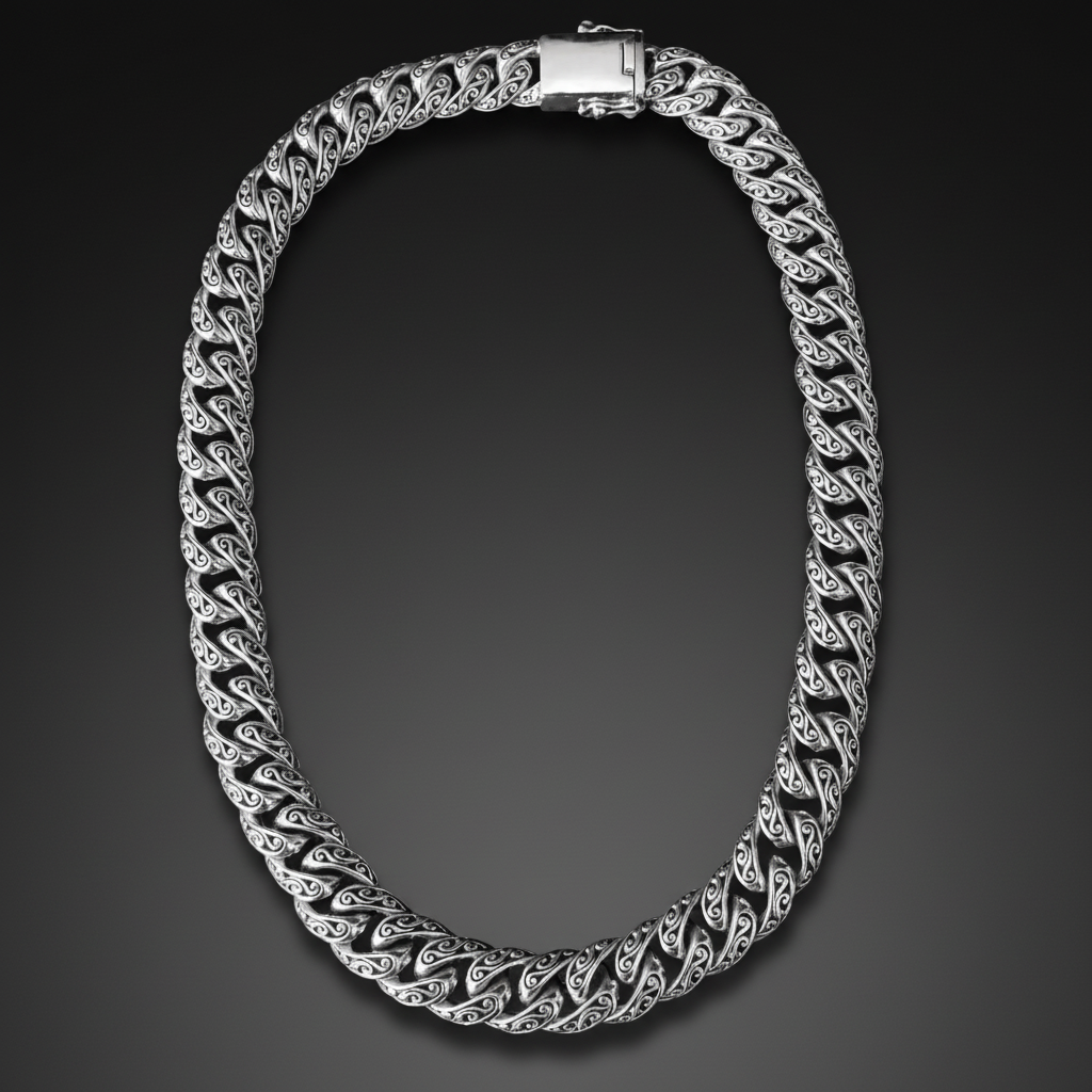 A silver-toned Cuban link chain necklace with a polished clasp, displayed against a solid black background.