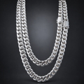 A double-strand silver Cuban link chain necklace with a polished rectangular clasp, displayed against a dark gray gradient background.