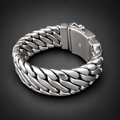 A chunky silver-toned metal bracelet with a woven curb-link design and a rectangular clasp, photographed on a dark gray to black gradient background.